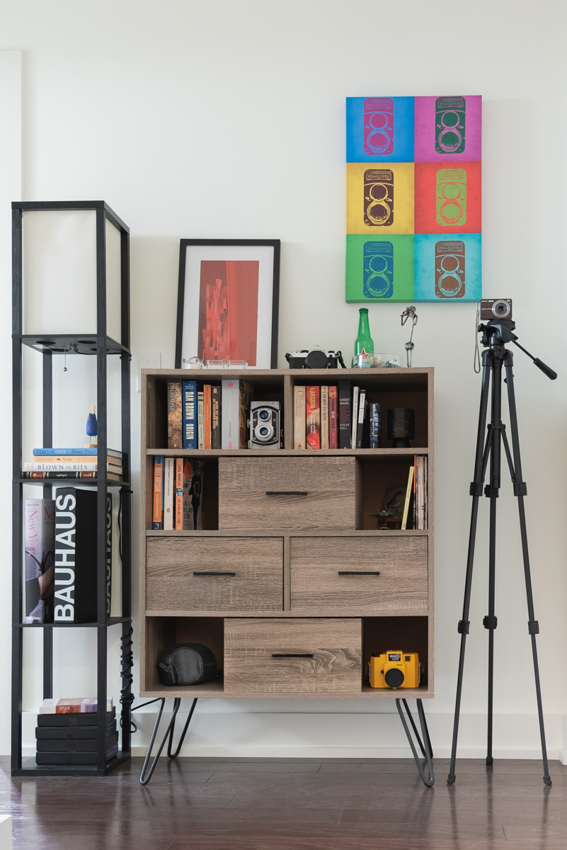 tripod by book shelf