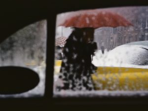 woman with umbrella, shot through car window