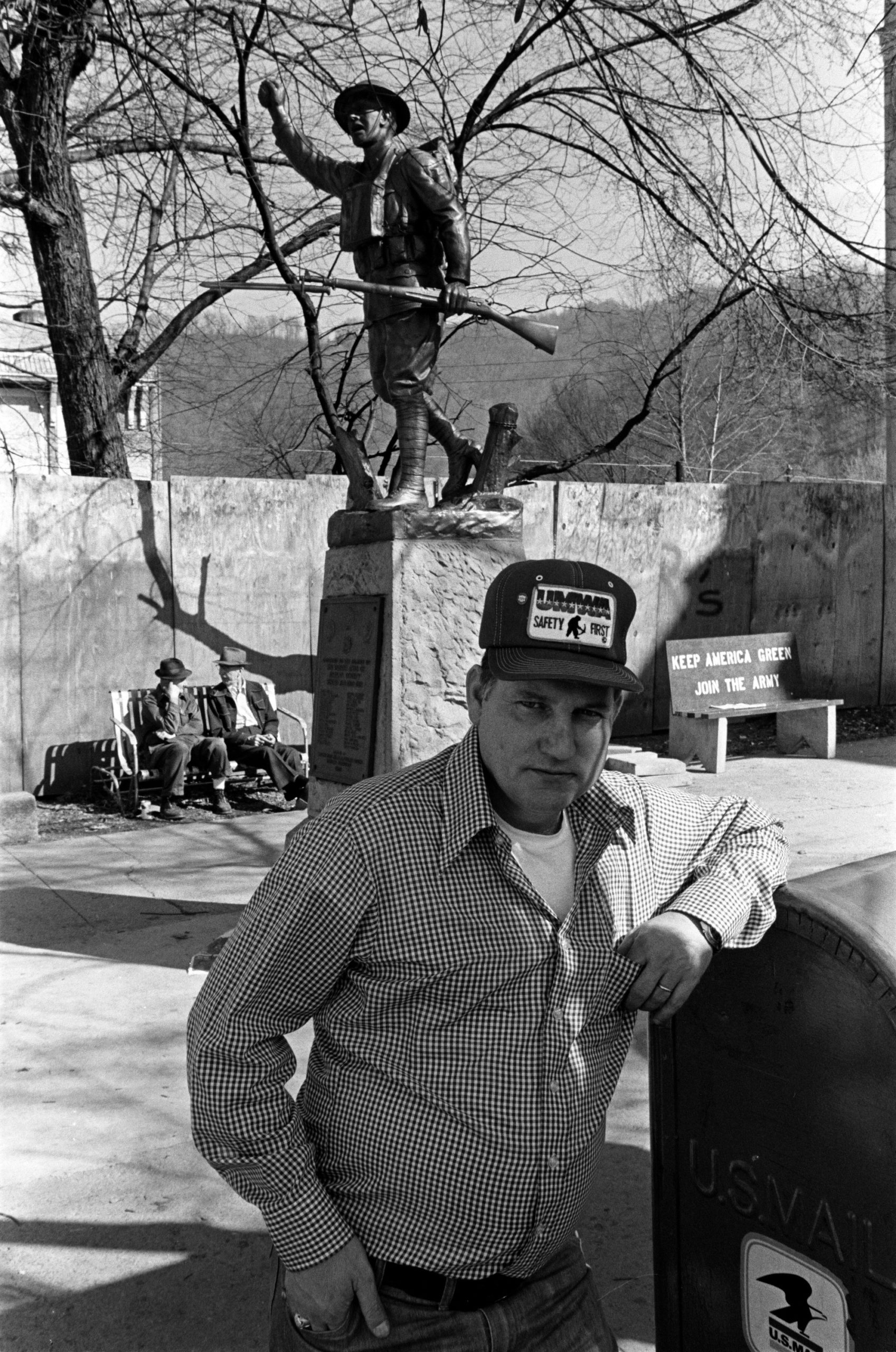 man leaning on car