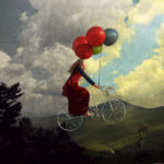 woman on bicycle with balloons