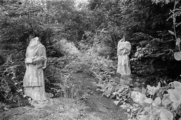 headless statues in forest
