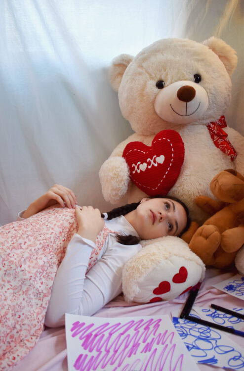 woman on bed with teddy bear