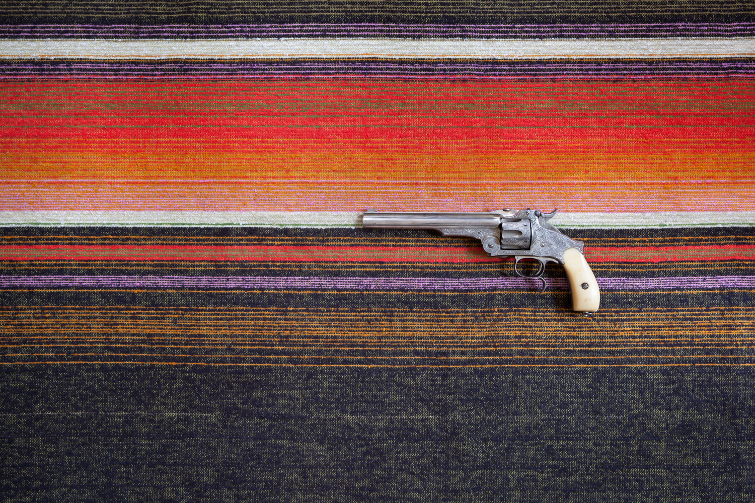 gun on mexican blanket