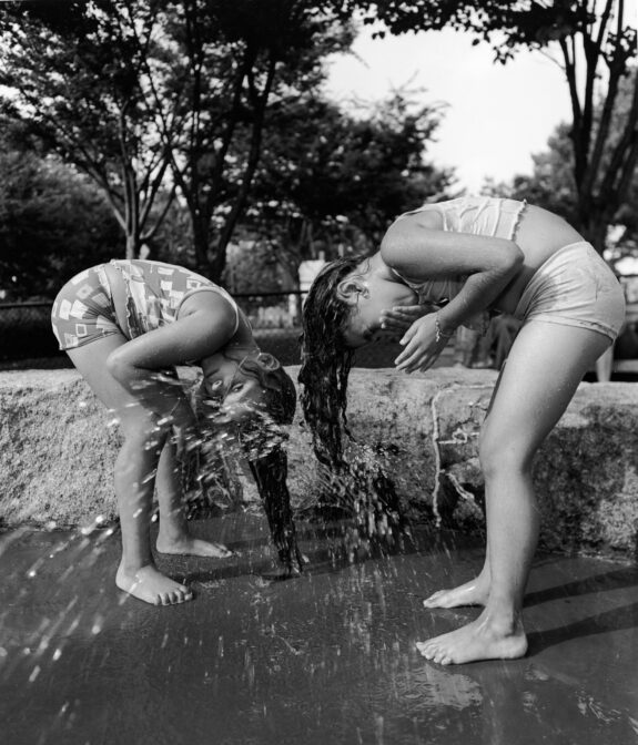 girls playing in the hose outside