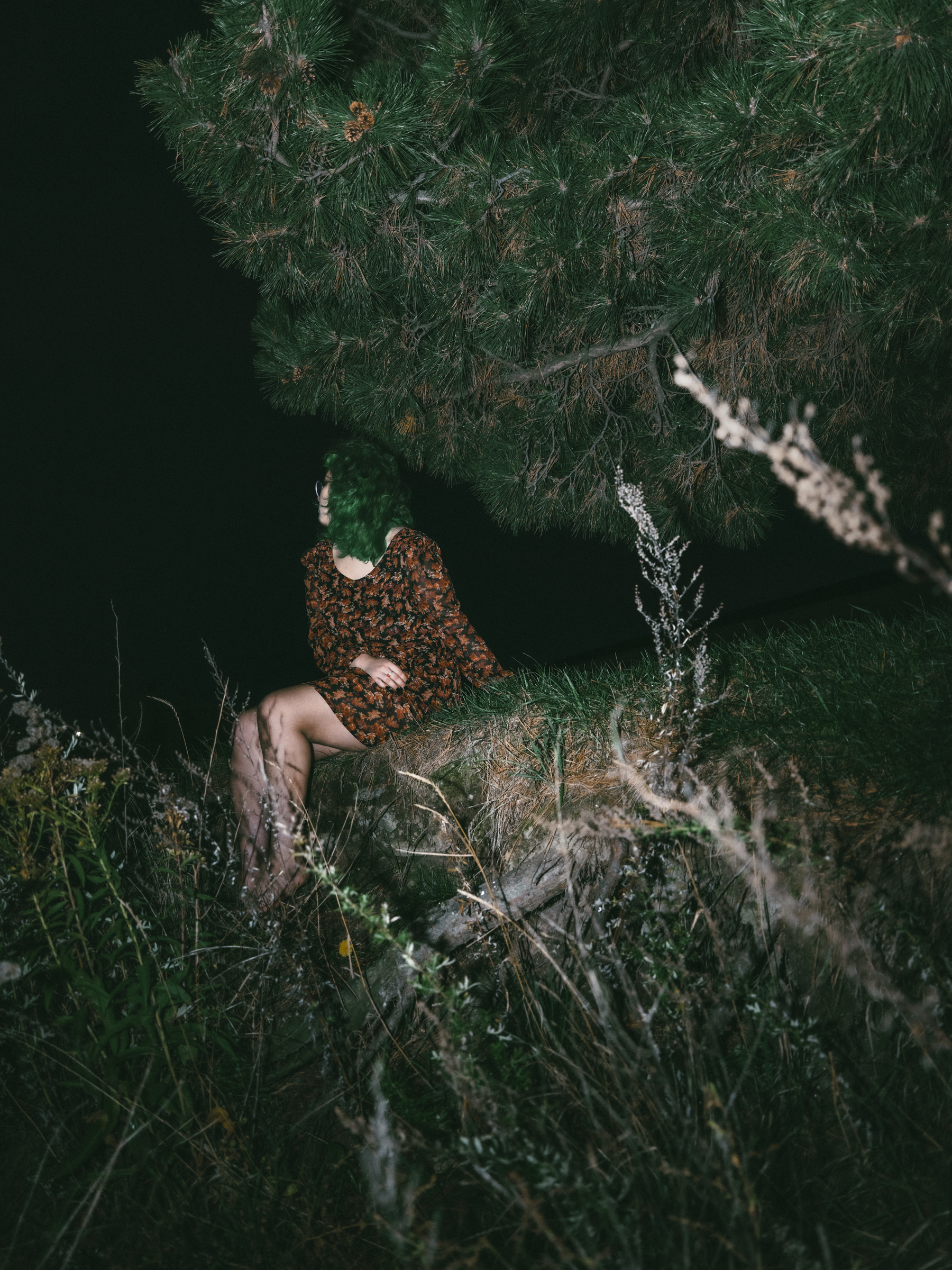 girl sitting in the dark in forest