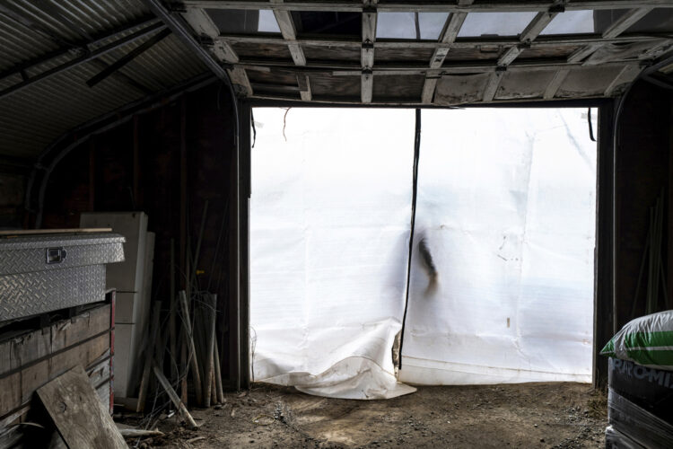 man walking out a plastic door