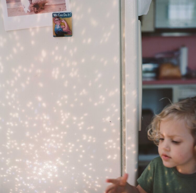 photo by Asheleigh Coleman titled yes. child with star light on a wall