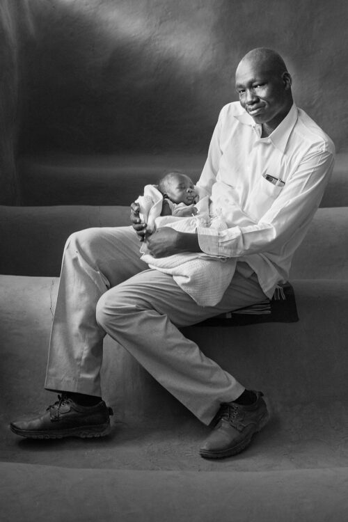 © Marti Corn, Peter and his 2-week old son Ayuen, 2018